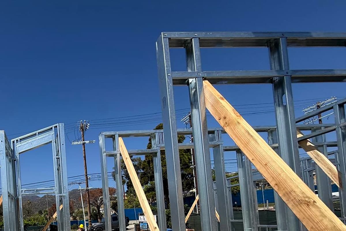 A temporary wood brace against a steel-framed door opening