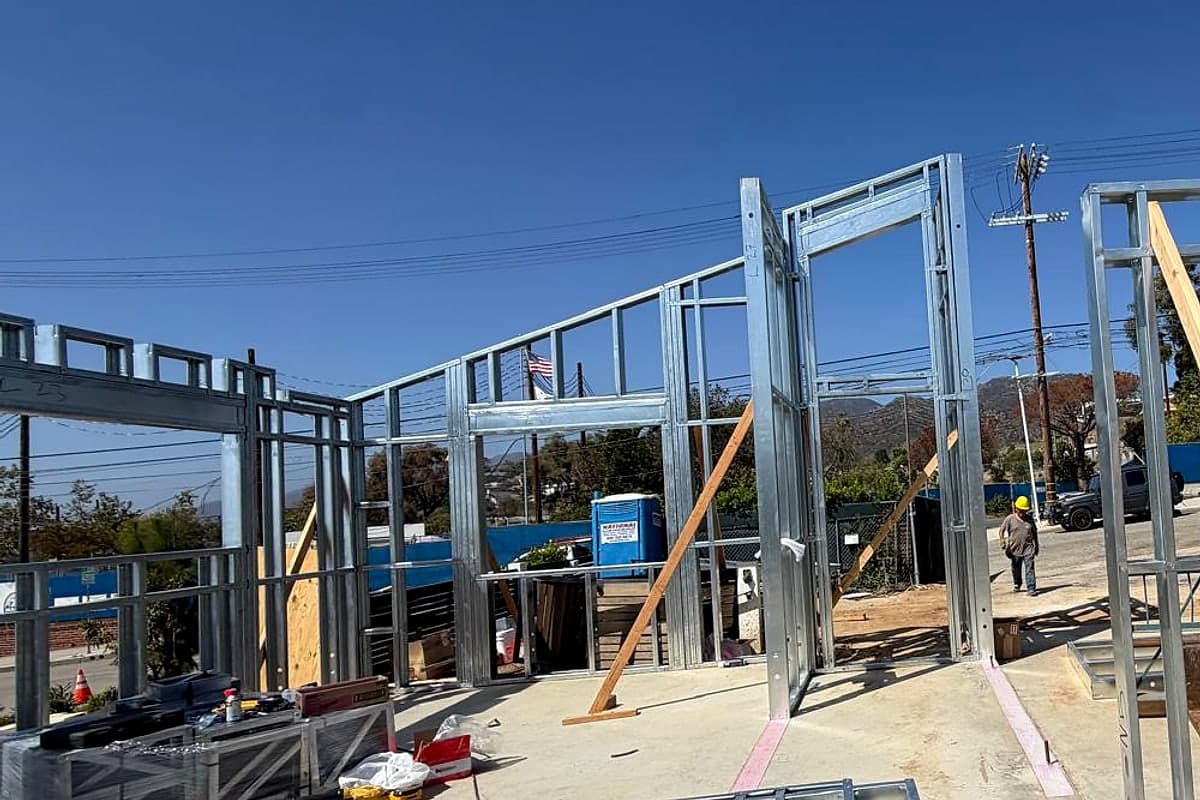Steel door frames and wall tracks fastened to the concrete slab