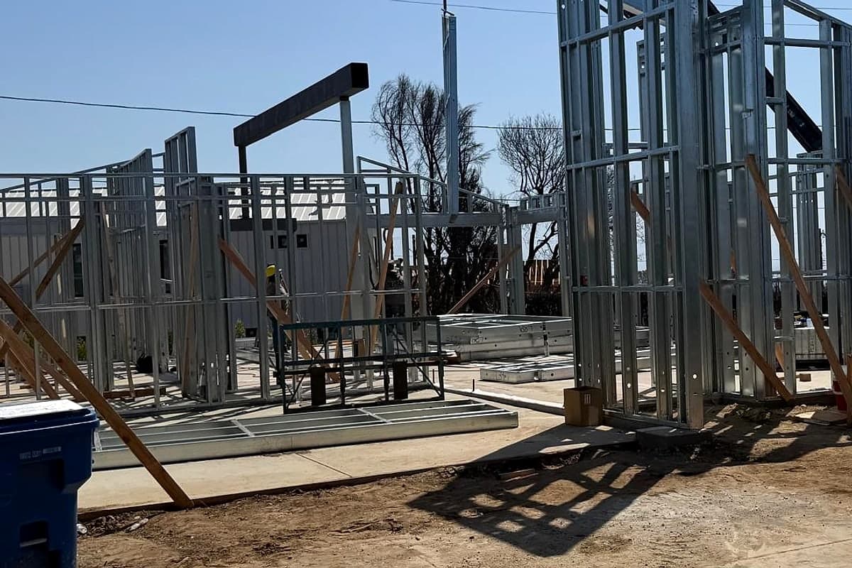 The first steel walls standing on the slab early in the build