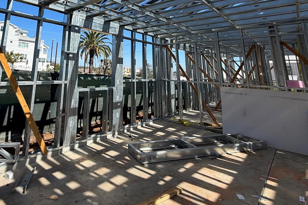 Shadows of the steel frame across the slab inside the house