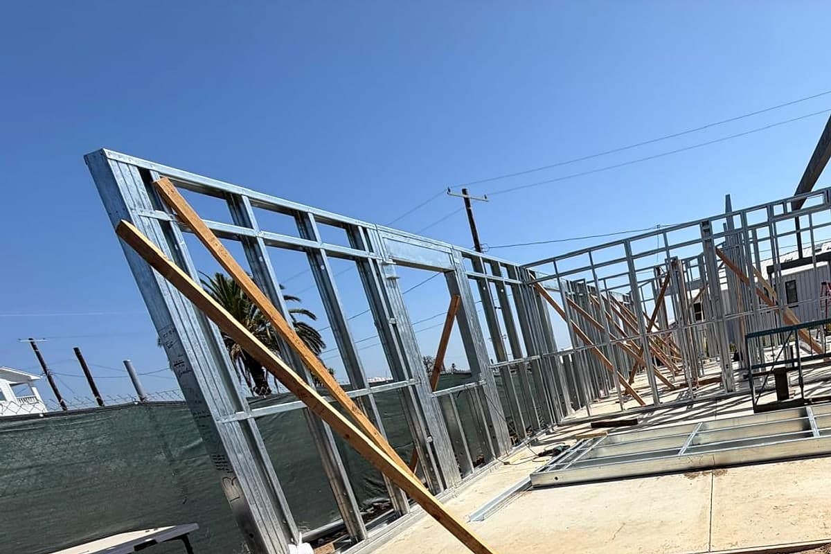 A braced steel wall frame on the slab, seen at a low angle